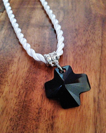 obsidian crystal cross contrasts with soft white twist cord