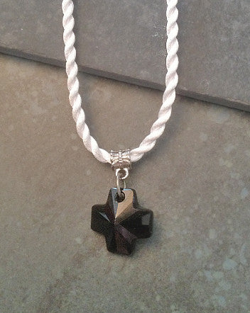 obsidian crystal cross contrasts with soft white twist cord