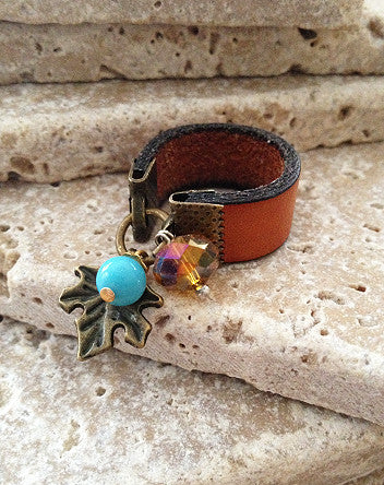 wide leather and bronzed leaf ring